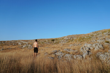 Boy watching to the sky in the mountain