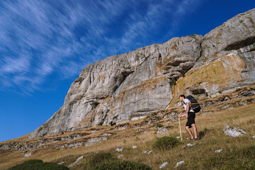 Boy walking in the mountain with a backpack
