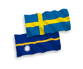 National vector fabric wave flags of Sweden and Republic of Nauru isolated on white background. 1 to 2 proportion.