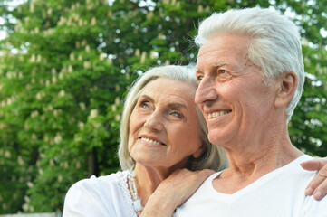 beautiful senior couple hugging   in the park