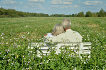 senior woman and man  sitting on bench