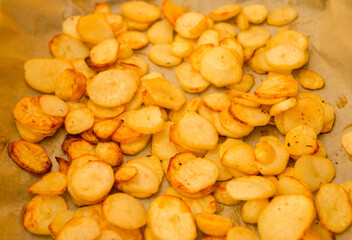 Baked potato slices on a roasting pan - last minute snack