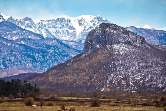 Zir hill and Velebit mountain snowy peaks in Lika landscape view