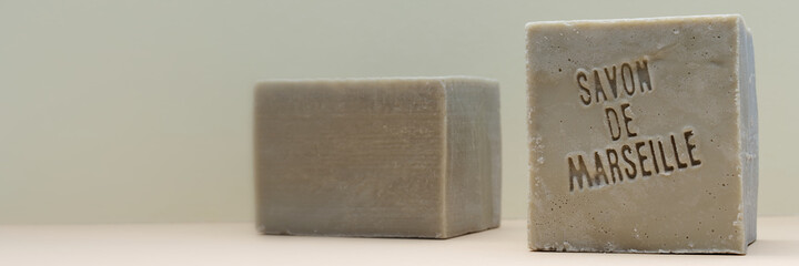 Traditional soap bar banner with copy space. Natural soap with French language text (translate: Soap from Marseille).