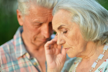 portrait of unhappy  senior couple in the park