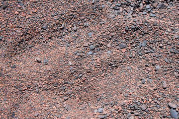 Red sand beach with volcanic stones, Maui, Hawaii, nature texture, background, close up