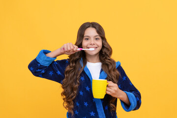 happy child girl in cozy bathrobe use toothbrush and cup, personal care