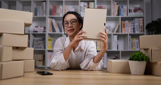 woman sell box online from camera