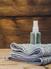 Alcohol gel bottle for hand washing Placed on a black and white striped towel Brown plank background with copy space on the left-hand side concept covid-19, disinfection.