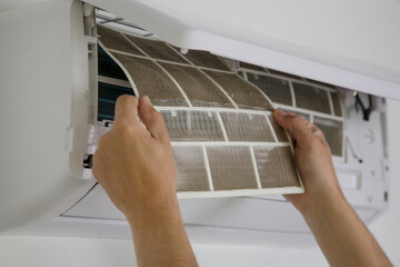 Man holding very dirty air conditioner filter