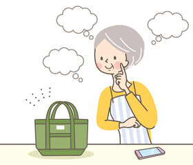 バッグの値段を考えているシニア女性