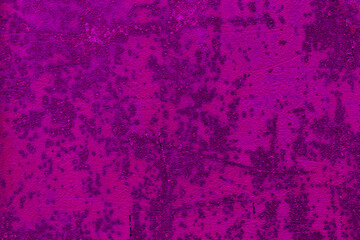 The abstract background is a texture of bright pink and magenta color made of metallic corrosion and rust surfaces. Fashionable rusted iron with spoiled old paint. High quality photo