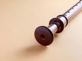 wooden baroque recorder close up look, isolated on yellow background