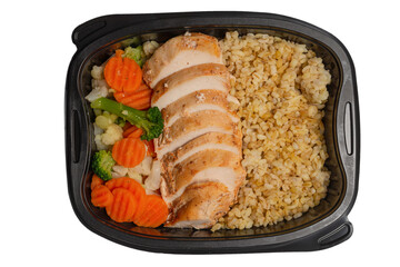 Ready food in a container. Stewed chicken, stewed carrot, cabbage and porridge.