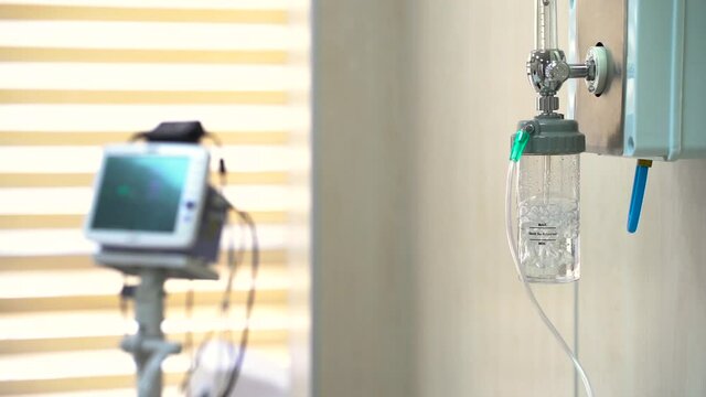 oxygen bottle gurgles during surgery and heart monitor in the background
