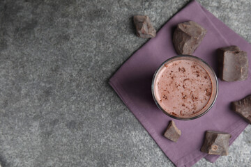 Delicious chocolate milk on grey table, flat lay. Space for text