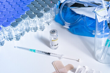 Vaccine against Coronavirus COVID-19 concept. Sterile vial and syringe with antivirus on the...