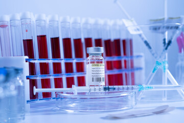 Vaccine against Coronavirus COVID-19 concept. Sterile vial and syringe with antivirus on the medical worker table. Cure from respiratory syndrome strain of Corona virus. Ready to administer the shot.