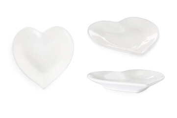 Set with empty heart shaped plates on white background