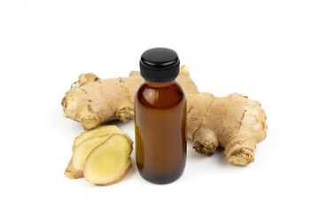 Ginger essential oil in bottle and fresh ginger isolated on white background. The scientific name is zingiber officinale. Herbs for health care concept.