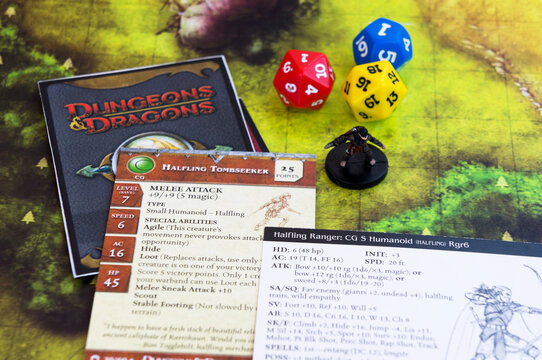 Dresden, July 19, 2020: Playing Dungeons and Dragons. Miniature fugures of rpg characters, skeleton in a cloack holding a sythe, dices and dragon. Board games.