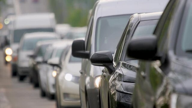 Many car moving slowly on road city traffic. Congestion street cars. Busy street scene city vehicle congestion transport car traffic jam rush highway city freeway. Urban scene traffic road slow motion