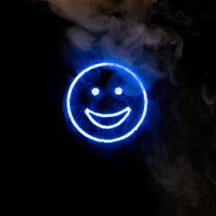 Stylized face expressing emotion glows through the stream of smoke in the dark