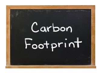 Obraz premium Carbon footprint written in white chalk on a black chalkboard isolated on white