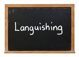 Obraz premium Languishing written in white chalk on a black chalkboard isolated on white