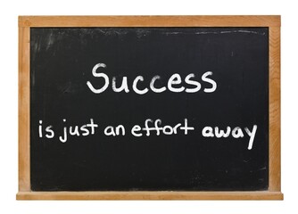 Success is just an effort away written in white chalk on a black chalkboard isolated on white