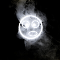 Stylized face expressing emotion glows through the stream of smoke in the dark