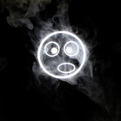 Stylized face expressing emotion glows through the stream of smoke in the dark