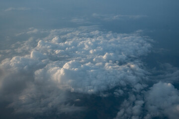 looking down on clouds at sunset from my airplane window