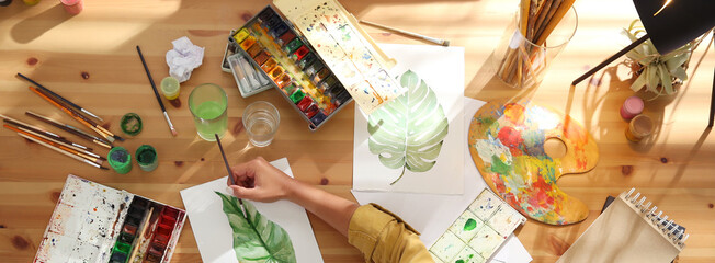 Young woman drawing at table indoors, top view. Banner design