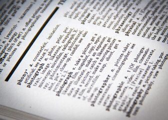 A close-up of the definition of a photograph in a dictionary and thesaurus