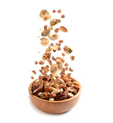 Delicious granola and nuts falling into bowl on white background. Healthy snack