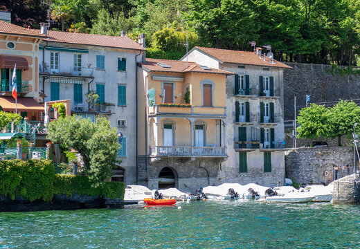 old colorful houses overlooking the small harbor with fishing boats.Moltrasio, Lombardy, Como lake, Italy.