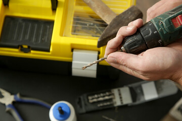 Handyman changing drill bit on a cordless drill