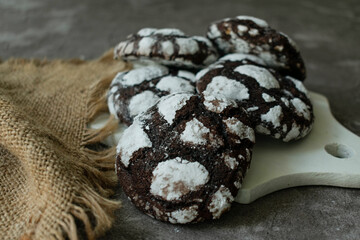 Chocolate homemade cookies on a wooden board.
Close-up.