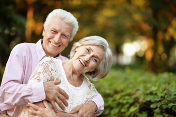 smiling senior couple  embracing   in autumn  park