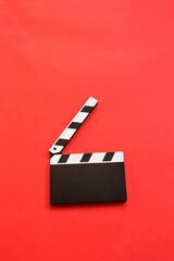 Movie clapper isolated on red background. Top view. Entertainment industry. Space for text....