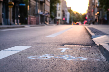 Separate bicycle lane for riding bicycles. A white bicycle symbol on the road. Selective focus