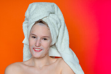 a girl with wet hair and a white towel on her head in a cosmetic mask