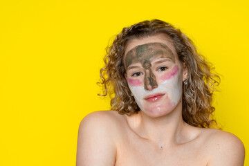 Girl with curly hair in the cosmetic, caring mask of three colors