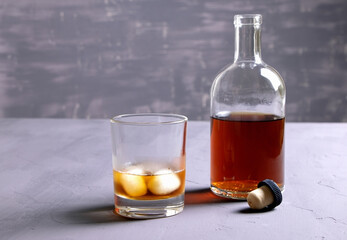 Alcohol. Bottle of whisky. A glass of scoth with ice. Copy space.