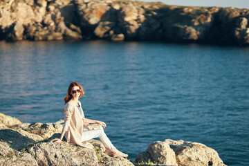 pretty traveler in a t-shirt resting on the beach in the mountains near the river in summer vacation Relax