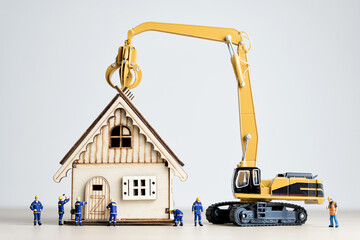 Figurines of builders and a crane working on the house