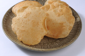 fried poori or puri made from wheat flour. Indian traditional food - obrazy, fototapety, plakaty