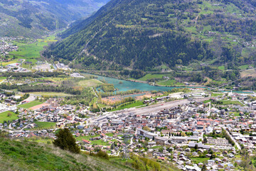 Fototapeta na wymiar aerial view on a city in european alps crossing by a river