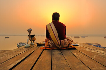 An Unidentified Hindu Brahman monk meditates on the ghat stairs of holy Ganges river